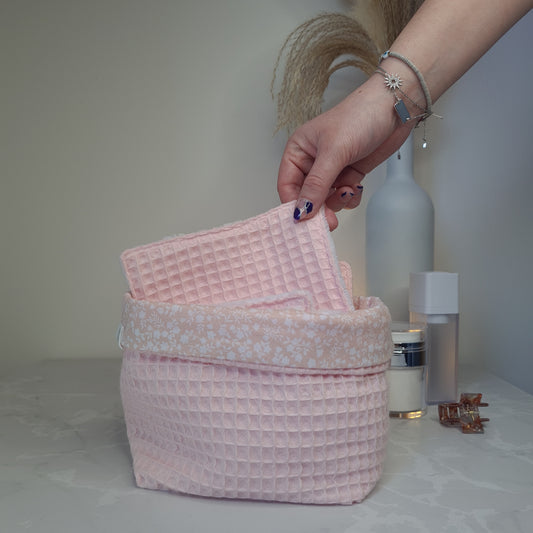 lingette réutilisable rose pale en nid d'abeille et eponge bambou blanc dans une paniere en nid d'abeille rose et tissu coton rose à fleurs blanches